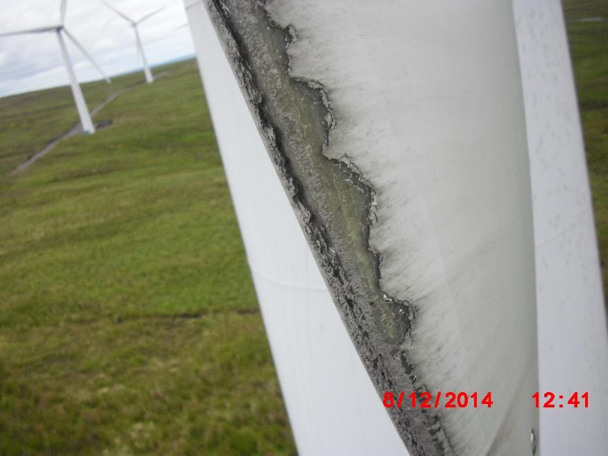 Close-up of rain erosion and damage to the leading edge of a wind-turbine blade